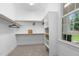 Bright, walk-in closet with custom shelving, hanging racks, and a window at 109 Henrys Ridge Rd, Pittsboro, NC 27312