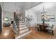 Elegant entryway with staircase, hardwood floors, and seamless transition to the dining and living areas at 109 Henrys Ridge Rd, Pittsboro, NC 27312