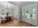Elegant Entryway flows into the Dining Room with hardwood floors and large windows for natural light at 109 Henrys Ridge Rd, Pittsboro, NC 27312