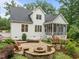 Backyard with paver patio, outdoor kitchen, fire pit, and screened in porch, hot tub with white siding home at 109 Henrys Ridge Rd, Pittsboro, NC 27312