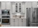 Bright kitchen with stainless appliances, white cabinets, granite counters, and a tiled backsplash at 109 Henrys Ridge Rd, Pittsboro, NC 27312