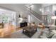 Inviting living room with hardwood floors, neutral color palette, and staircase access to the upper level at 109 Henrys Ridge Rd, Pittsboro, NC 27312