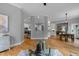 Spacious living room with hardwood floors, open to kitchen and dining area, and a glass coffee table on a rug at 109 Henrys Ridge Rd, Pittsboro, NC 27312