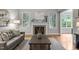 Cozy living room features a fireplace, large windows, and comfortable seating, creating an inviting space at 109 Henrys Ridge Rd, Pittsboro, NC 27312