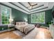 The main bedroom features tray ceiling, hardwood floors, and natural light from surrounding windows at 109 Henrys Ridge Rd, Pittsboro, NC 27312