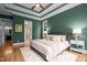 The main bedroom features tray ceiling, hardwood floors, and natural light from surrounding windows at 109 Henrys Ridge Rd, Pittsboro, NC 27312