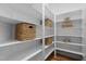Spacious pantry featuring abundant white shelving and woven storage baskets for optimal organization at 109 Henrys Ridge Rd, Pittsboro, NC 27312