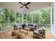 Inviting screened porch with ceiling fan, comfortable seating, and wood flooring for relaxing outdoors at 109 Henrys Ridge Rd, Pittsboro, NC 27312