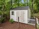 Well-maintained shed in a fenced-in yard with landscaping and mature trees at 109 Henrys Ridge Rd, Pittsboro, NC 27312