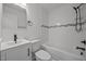 Clean bathroom with updated tile, modern vanity, and bathtub with shower at 111 S Gaylee Lake Dr, Wendell, NC 27591
