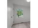 Bright bedroom with neutral walls, flooring, door, and window with wooded view at 111 S Gaylee Lake Dr, Wendell, NC 27591