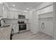 Modern kitchen with stainless steel appliances and adjacent pantry storage at 111 S Gaylee Lake Dr, Wendell, NC 27591