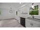 Bright kitchen features white cabinets, granite countertops and stainless steel appliances at 111 S Gaylee Lake Dr, Wendell, NC 27591