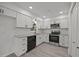 Well-lit kitchen with white cabinetry, stainless steel appliances, and hardwood floors at 111 S Gaylee Lake Dr, Wendell, NC 27591