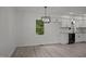 Modern kitchen with white cabinets, granite countertops, and stainless steel appliances at 111 S Gaylee Lake Dr, Wendell, NC 27591
