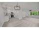 Bright living space featuring an open layout, modern chandelier, and wood-look flooring at 111 S Gaylee Lake Dr, Wendell, NC 27591