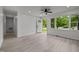 Inviting living area with an open door, ceiling fan, and large window views at 111 S Gaylee Lake Dr, Wendell, NC 27591