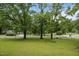 Lush green lawn with mature shade trees and views of the surrounding neighborhood at 111 S Gaylee Lake Dr, Wendell, NC 27591