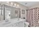 Bright bathroom featuring double sinks, vanity with lots of storage and a walk-in shower at 11113 N Radner Way, Raleigh, NC 27613