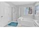 Bright bathroom featuring a walk-in shower, soaking tub, and a window at 11113 N Radner Way, Raleigh, NC 27613
