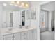Bright bathroom featuring double sinks, vanity with lots of storage and a window at 11113 N Radner Way, Raleigh, NC 27613