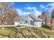 Beautiful one-story home with blue siding, blue shutters, a manicured lawn, and lovely mature tree at 11113 N Radner Way, Raleigh, NC 27613
