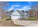 Charming one-story home with blue siding, attached garage, blue shutters and a well-kept lawn at 11113 N Radner Way, Raleigh, NC 27613