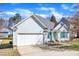 One-story home with blue siding, blue shutters, an attached garage, and a well-maintained lawn at 11113 N Radner Way, Raleigh, NC 27613
