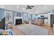 Open-concept living room with a fireplace and a view of the modern kitchen at 11113 N Radner Way, Raleigh, NC 27613