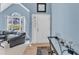 Inviting living room with blue walls, carpet flooring, and plenty of natural light at 11113 N Radner Way, Raleigh, NC 27613