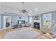 Cozy living room featuring a fireplace, ceiling fan, and comfortable seating arrangement at 11113 N Radner Way, Raleigh, NC 27613