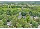 An aerial view pinpoints a home nestled in a lush neighborhood with mature trees offering privacy at 113 Bergeron Way, Cary, NC 27519