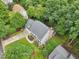 Aerial view showcasing the home, driveway, and manicured lawn, surrounded by lush greenery and neighboring properties at 113 Bergeron Way, Cary, NC 27519