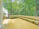 A large back deck with built-in seating and views of the wooded backyard at 113 Bergeron Way, Cary, NC 27519