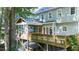 Back exterior shot shows a spacious multi-level deck with a screened-in porch provides an area for enjoying the serene outdoors at 113 Bergeron Way, Cary, NC 27519