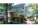 Back exterior view of house showing the multi-level deck, screened-in porch, and backyard area with wooded surroundings at 113 Bergeron Way, Cary, NC 27519