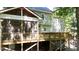 Back exterior features a spacious deck and screened-in porch offers seamless transitions for enjoying the serenity of the surroundings at 113 Bergeron Way, Cary, NC 27519