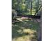 Overlooking a private backyard featuring a wooden fence and mature trees providing plenty of shade and privacy at 113 Bergeron Way, Cary, NC 27519