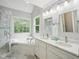 Bathroom featuring double sinks, a garden tub, and a glass shower at 113 Bergeron Way, Cary, NC 27519