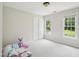 Neutral bedroom with plush carpet, two large windows, and closet at 113 Bergeron Way, Cary, NC 27519