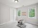 Bright bedroom with natural light, a chair, and closet doors at 113 Bergeron Way, Cary, NC 27519