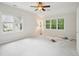 Bright bedroom with neutral walls, two windows, and ceiling fan at 113 Bergeron Way, Cary, NC 27519