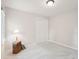Bedroom with large window, closet with sliding doors, and light carpet at 113 Bergeron Way, Cary, NC 27519