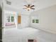 Bedroom with a window seat nook, ceiling fan, and closet doors at 113 Bergeron Way, Cary, NC 27519