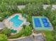 A community pool and tennis courts surrounded by trees and lush landscaping at 113 Bergeron Way, Cary, NC 27519