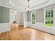 A bright dining room features chair rail, hardwood floors, and large windows for natural light at 113 Bergeron Way, Cary, NC 27519