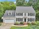 Charming two-story home with a well-manicured lawn and a two-car garage at 113 Bergeron Way, Cary, NC 27519