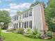 Exterior view of a two-story home with a brick chimney and lovely landscaped yard at 113 Bergeron Way, Cary, NC 27519