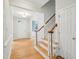 Bright foyer showcasing hardwood floors, staircase, and open entryway to living area at 113 Bergeron Way, Cary, NC 27519