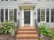 Close-up of the home's front door, featuring brick steps and attractive landscaping at 113 Bergeron Way, Cary, NC 27519